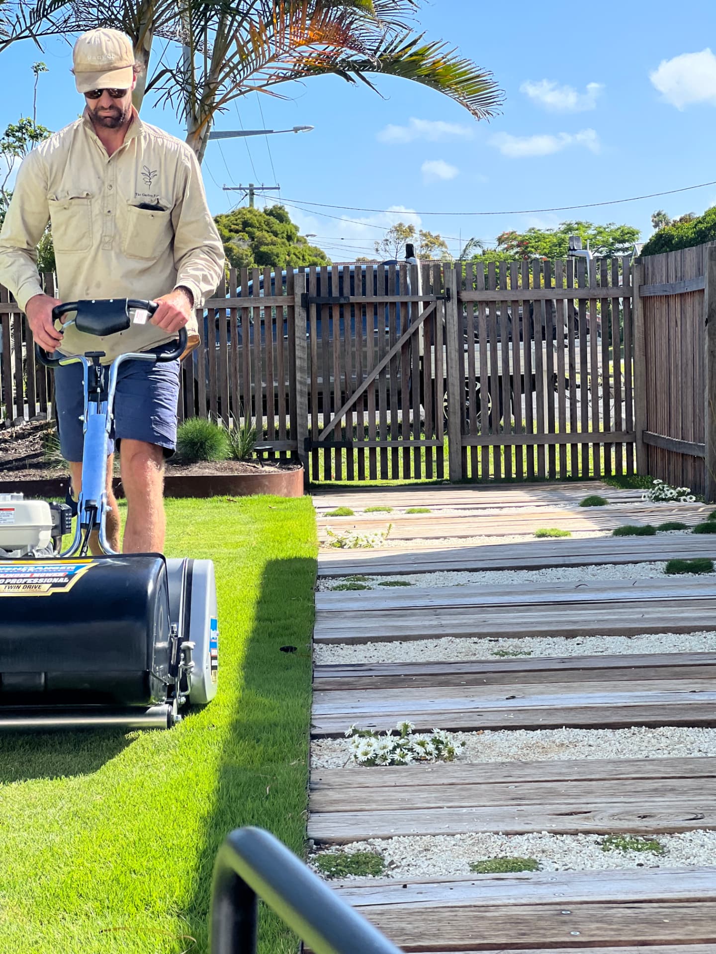 Matt, founder of The Garden Folk, mowing a Northern Rivers lawn